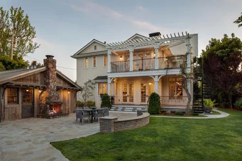 a front view of a house with a garden and plants