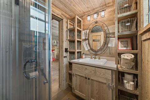 a bathroom with a sink vanity and a mirror