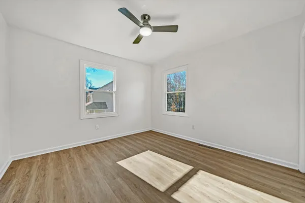 wooden floor in an empty room with a window