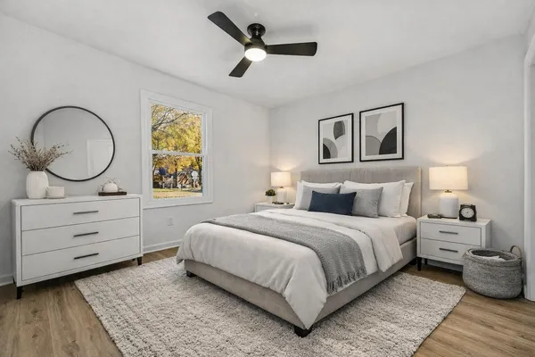a bedroom with a bed and a chandelier