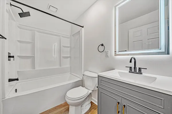 a bathroom with a sink a toilet and a bathtub