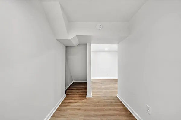 a view of a hallway with wooden floor