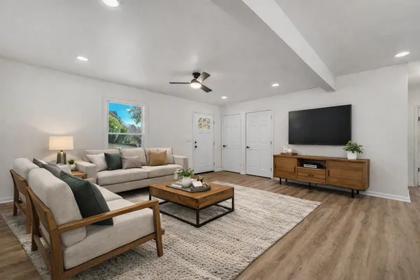 a living room with furniture and a flat screen tv