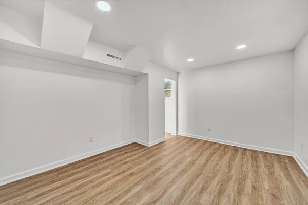 a view of room with wooden floor