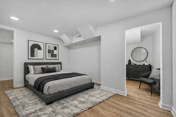 a bedroom with a bed and wooden floor