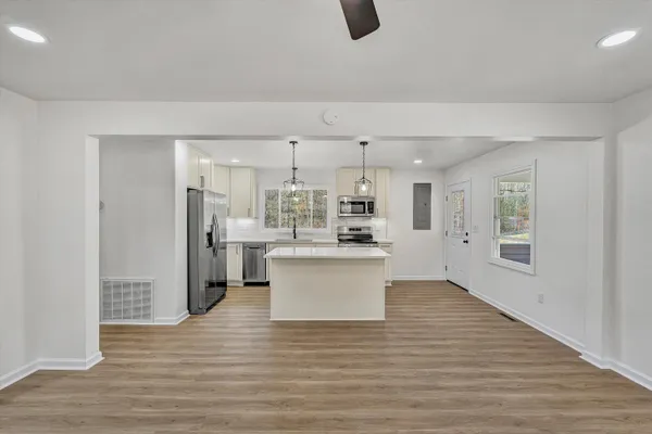 a view of a kitchen with wooden floor