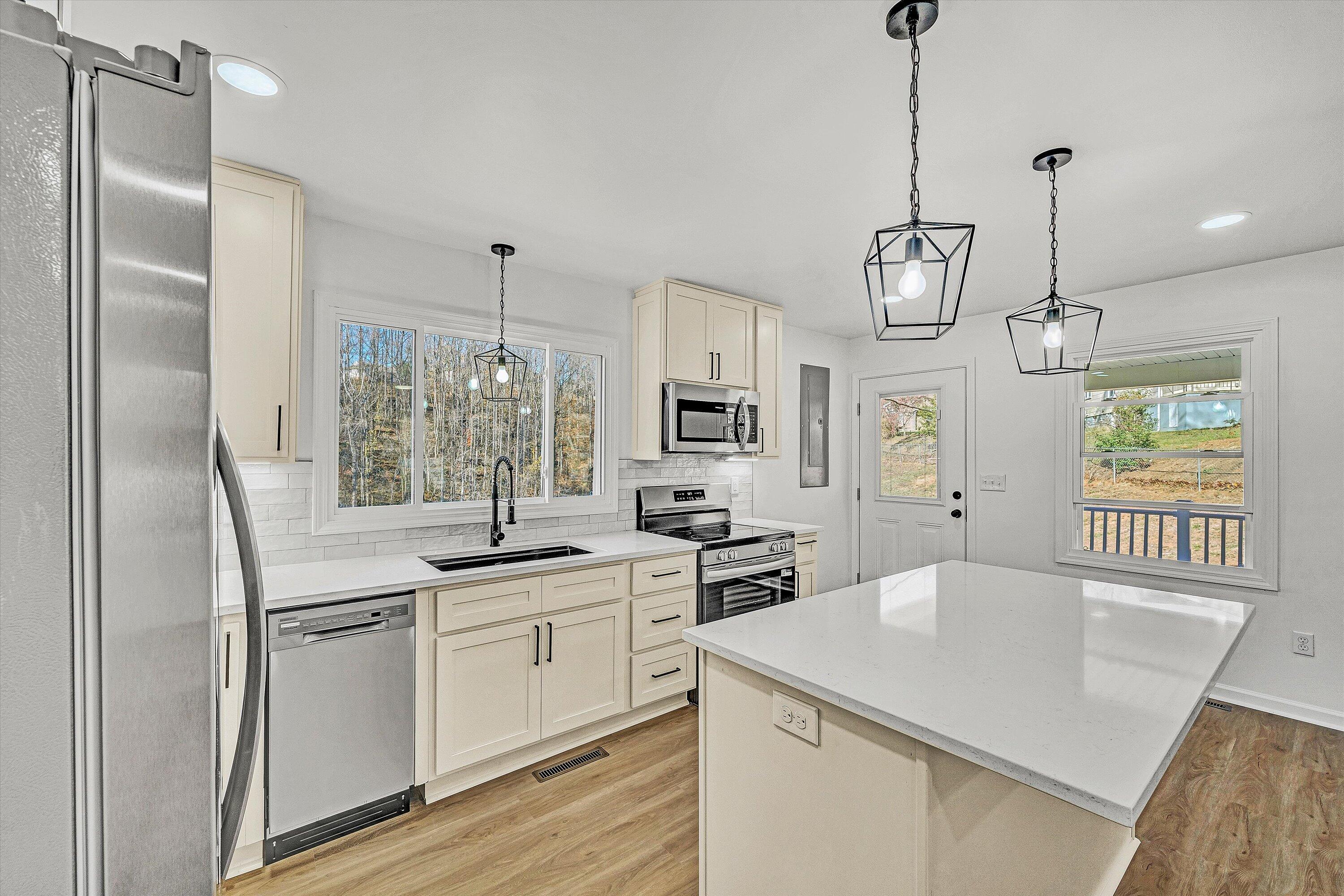 5962 2 Ford Road Roanoke, VA 24018 - Photo 9 of 39 a kitchen with stainless steel appliances granite countertop a sink a refrigerator and a stove