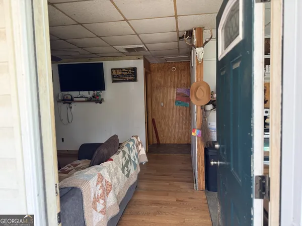 a bedroom with a bed and a flat tv screen