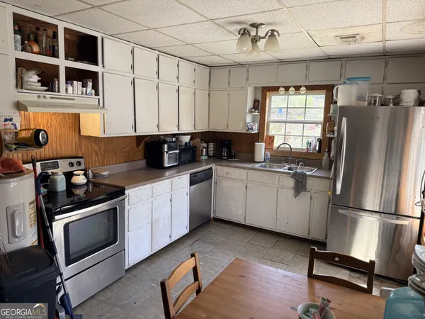 a kitchen with a sink cabinets and stainless steel appliances