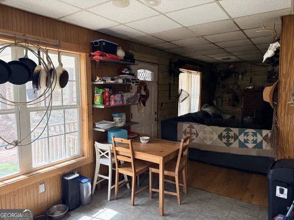 a view of a dining room with furniture and a window