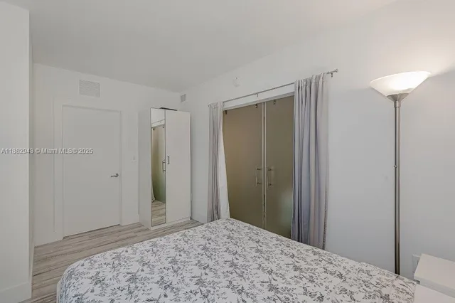 a bedroom with a bed and a view of bathroom