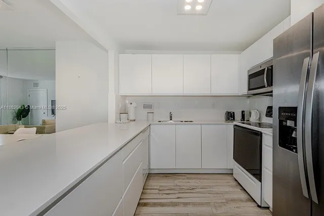 a kitchen with a sink cabinets and stainless steel appliances