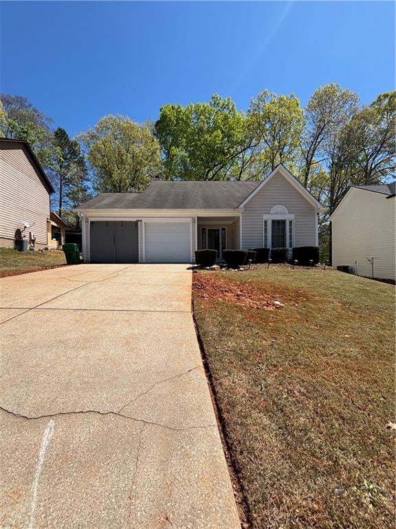 4949 Penscot Way Stone Mountain, GA 30088 - Photo 3 of 40 a front view of a house with a yard