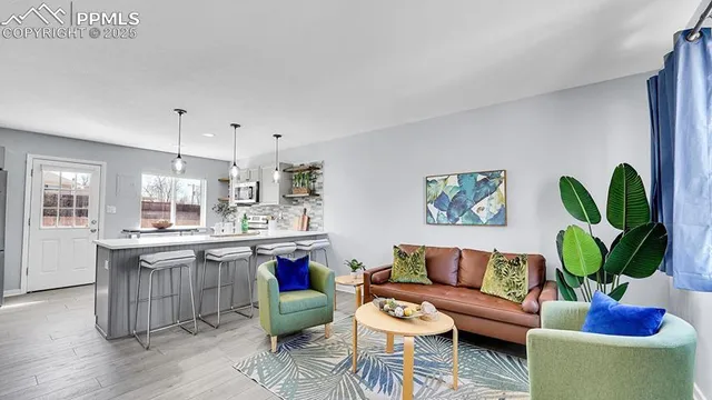 a living room with furniture and a potted plant