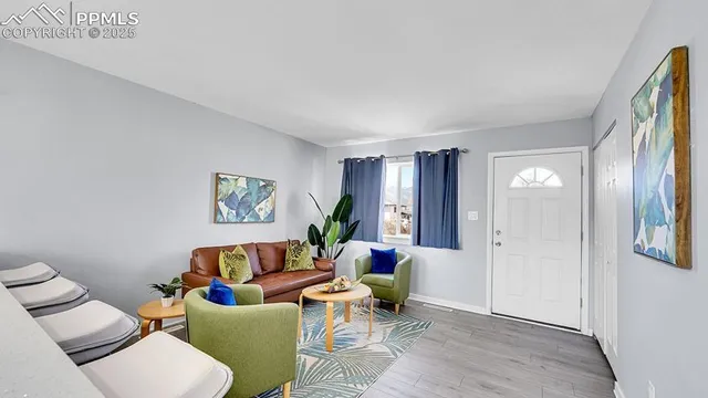 a living room with furniture and wooden floor