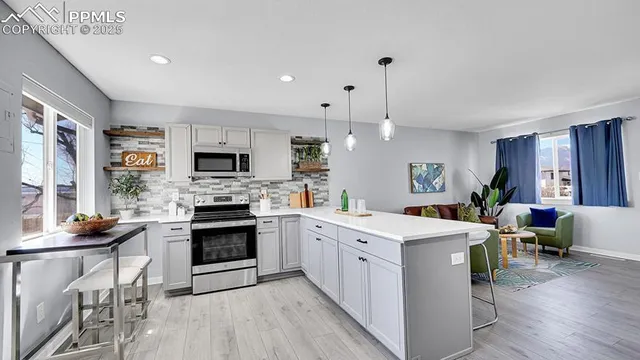 a kitchen with a sink stove and cabinets