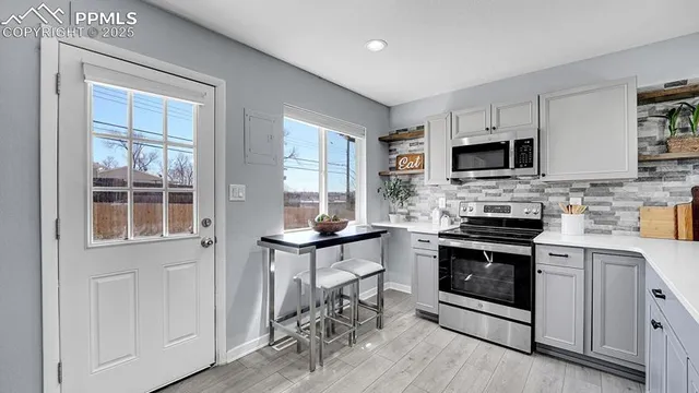 a kitchen with a stove a sink and a microwave