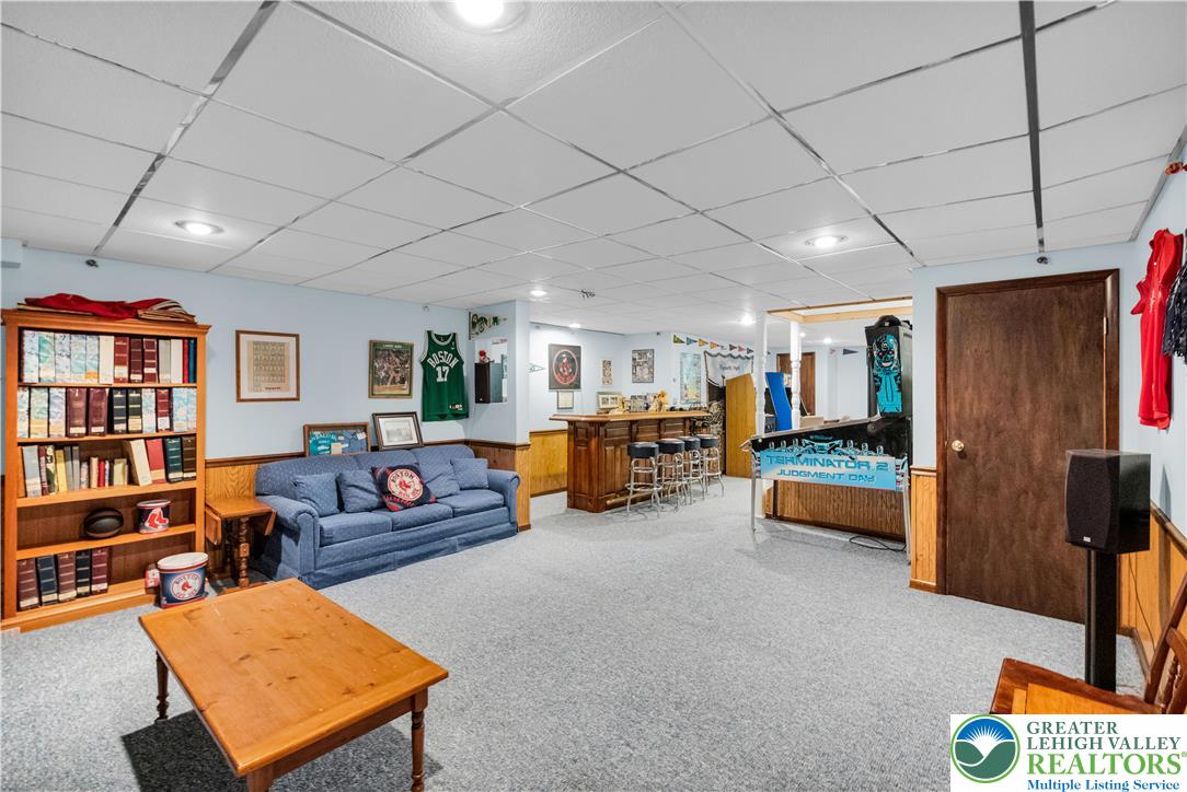3830 McIntosh Drive Orefield, PA 18069 - Photo 22 of 36 a living room with furniture gym equipment and a flat screen tv