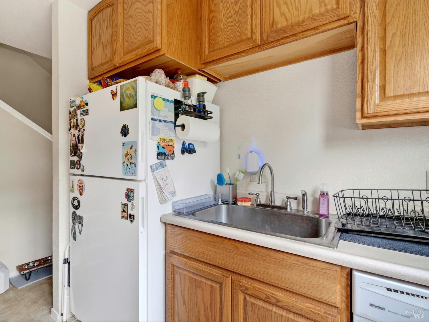 100-102 West 8th Street Santa Rosa, CA 95401 - Photo 21 of 32 a kitchen with a refrigerator and cabinets