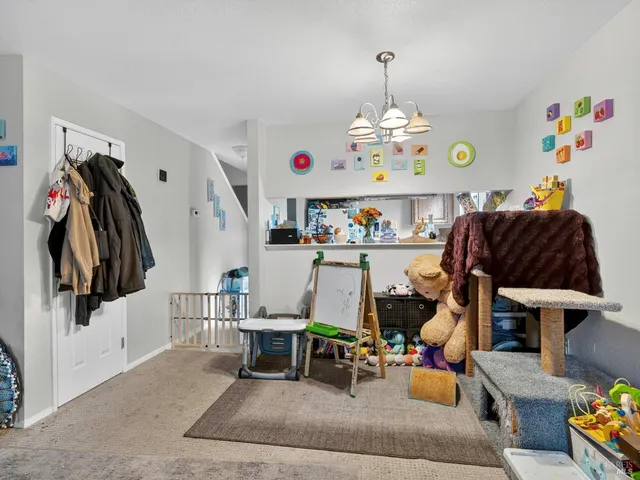 a living room with furniture a window and a chandelier
