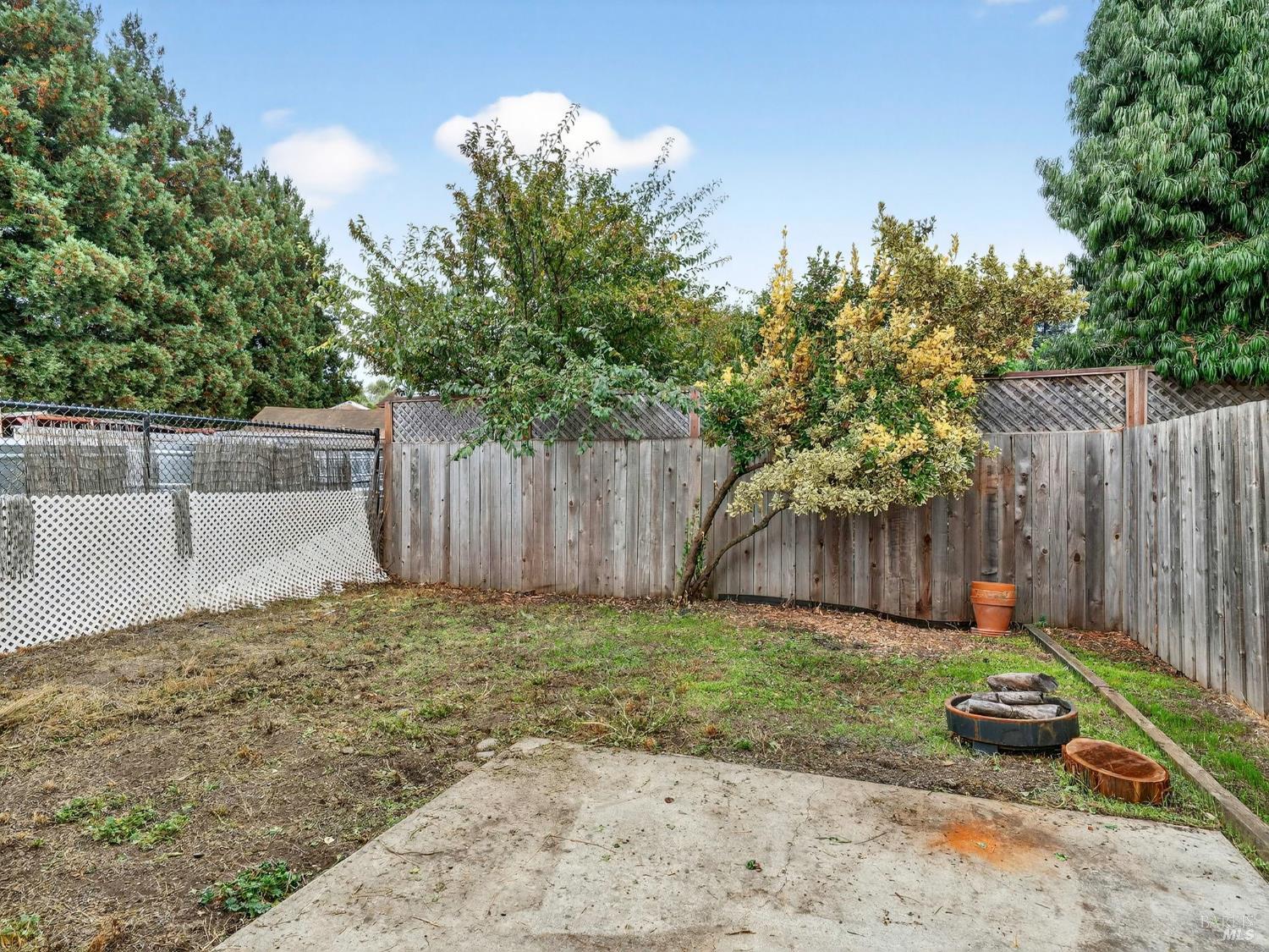 100-102 West 8th Street Santa Rosa, CA 95401 - Photo 27 of 32 a view of a backyard with wooden fence and a bench