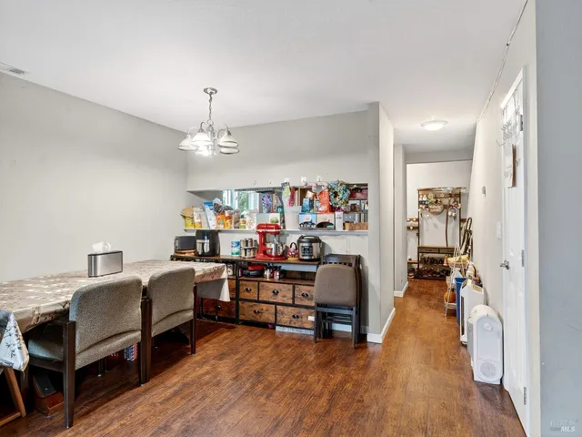 a view of a workspace with furniture and wooden floor