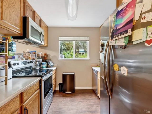 a kitchen that has a lot of cabinets a sink and a stove