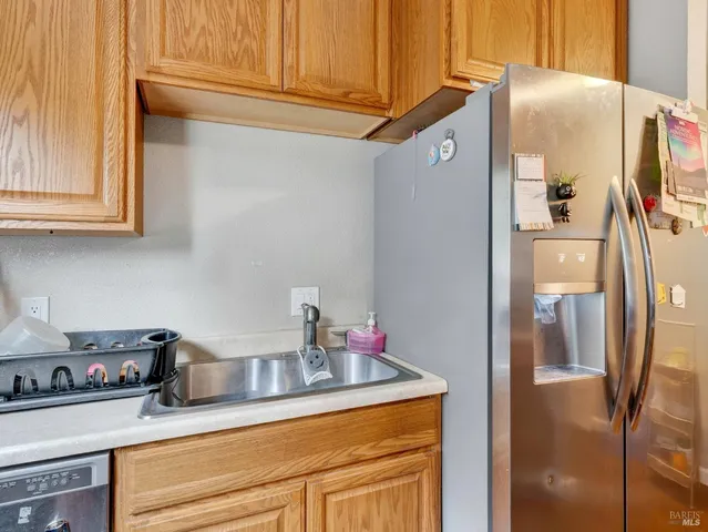 a kitchen with stainless steel appliances granite countertop a refrigerator and a sink