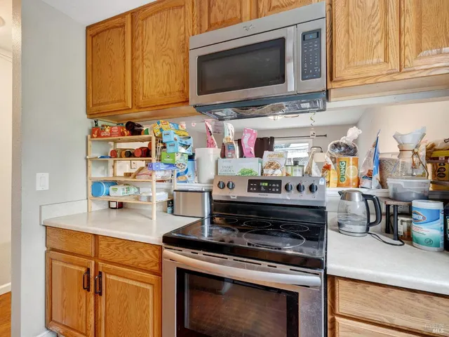 a kitchen with lots of counter top space and stainless steel appliances