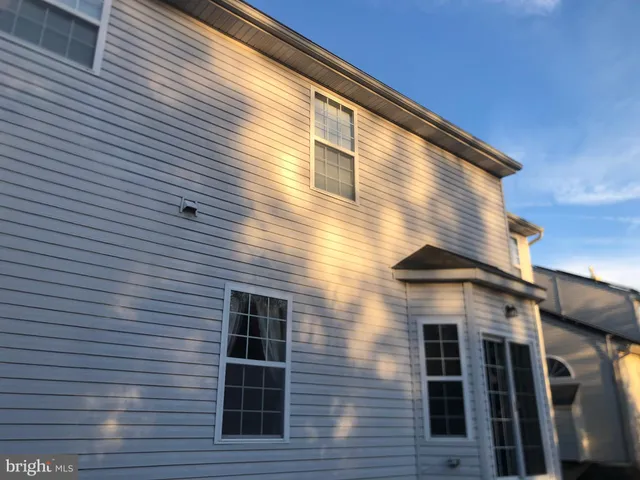 a view of backyard with wooden stairs