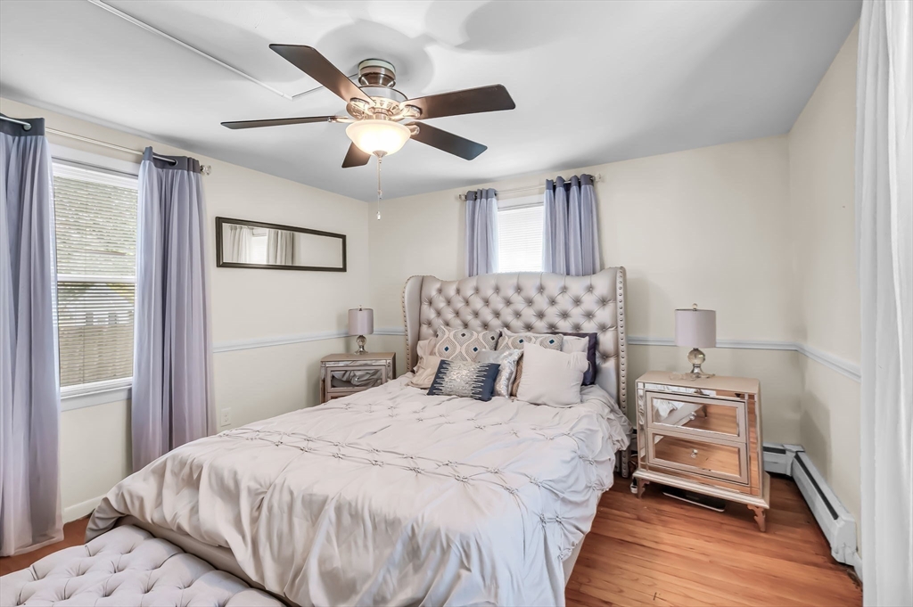 23 Gatewood Road Springfield, MA 01119 - Photo 15 of 31 a bedroom with a large bed and a chandelier