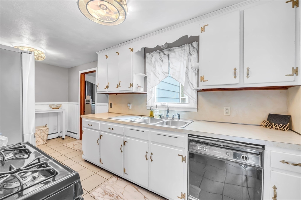 23 Gatewood Road Springfield, MA 01119 - Photo 2 of 31 a kitchen with a sink stove and cabinets