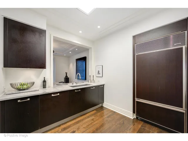 a kitchen with a sink and a mirror
