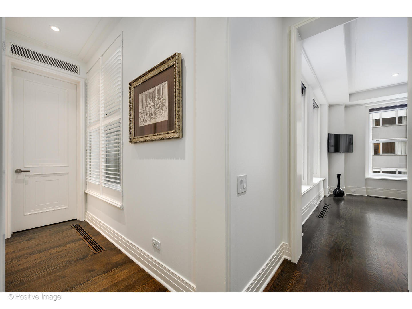 159 East Walton Place, Unit 7G Chicago, IL 60611 - Photo 23 of 37 a view of an empty room with a window and wooden floor