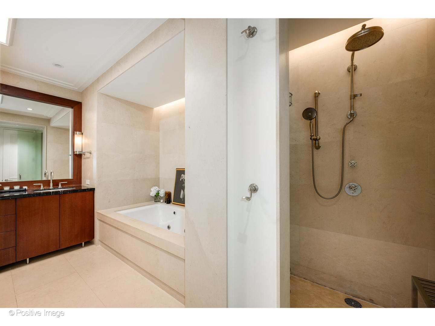 159 East Walton Place, Unit 7G Chicago, IL 60611 - Photo 26 of 37 a en suite bathroom with a tub shower and mirror