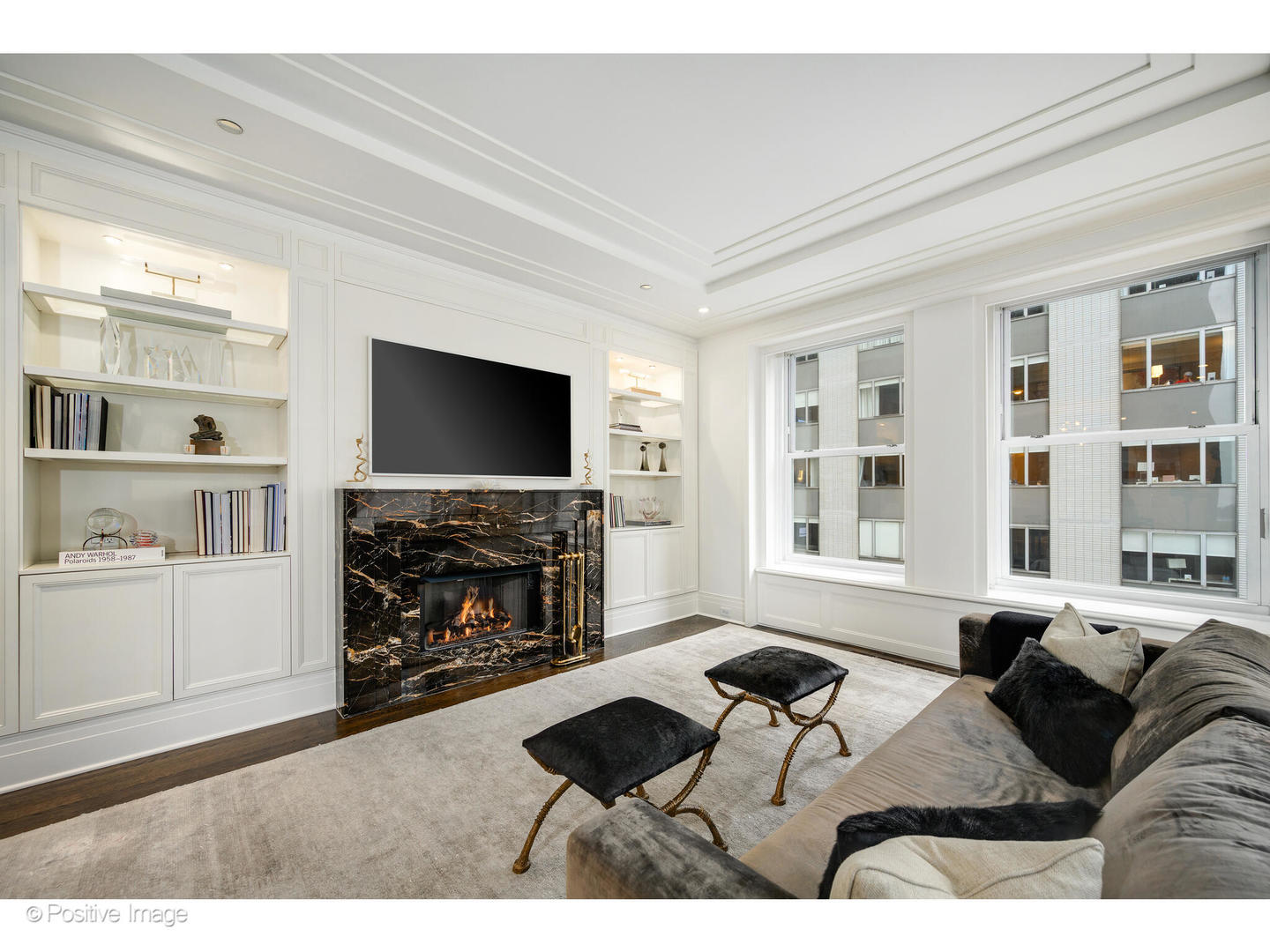 159 East Walton Place, Unit 7G Chicago, IL 60611 - Photo 7 of 37 a living room with furniture a flat screen tv and a fireplace