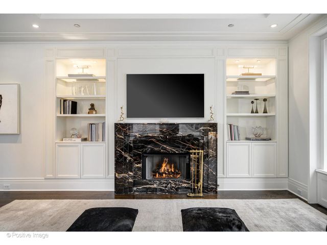 a living room with a fireplace and a flat screen tv