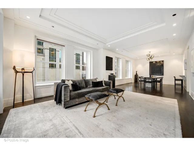 a living room with furniture and a kitchen