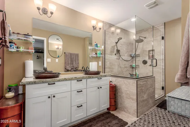 a spacious bathroom with a granite countertop sink mirror and shower