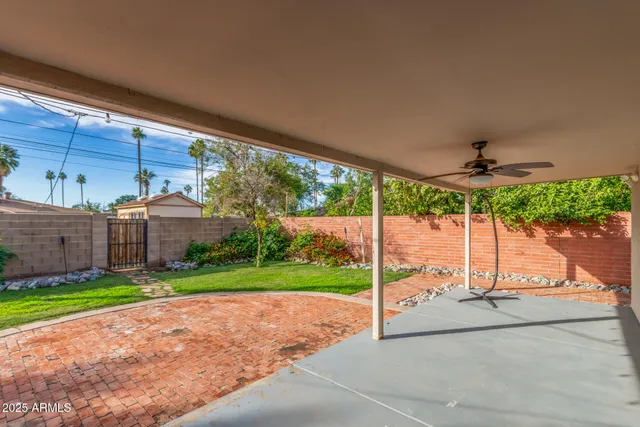 a view of a house with a backyard