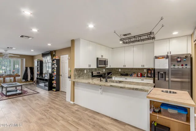 a kitchen with counter top space cabinets and stainless steel appliances