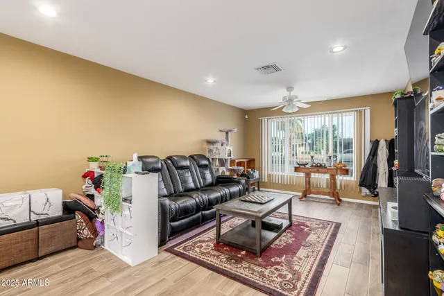 a living room with furniture and a floor to ceiling window