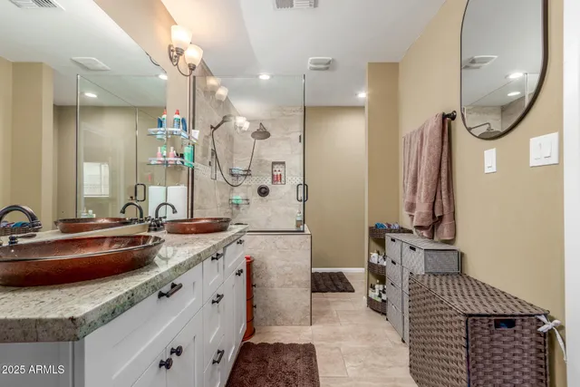 a spacious bathroom with a sink a toilet a mirror and shower