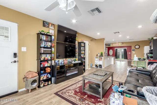 a living room with furniture and a bookshelf