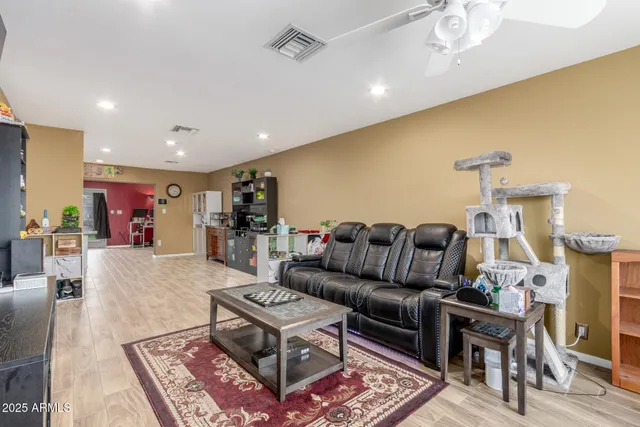 a living room with furniture and a wooden floor