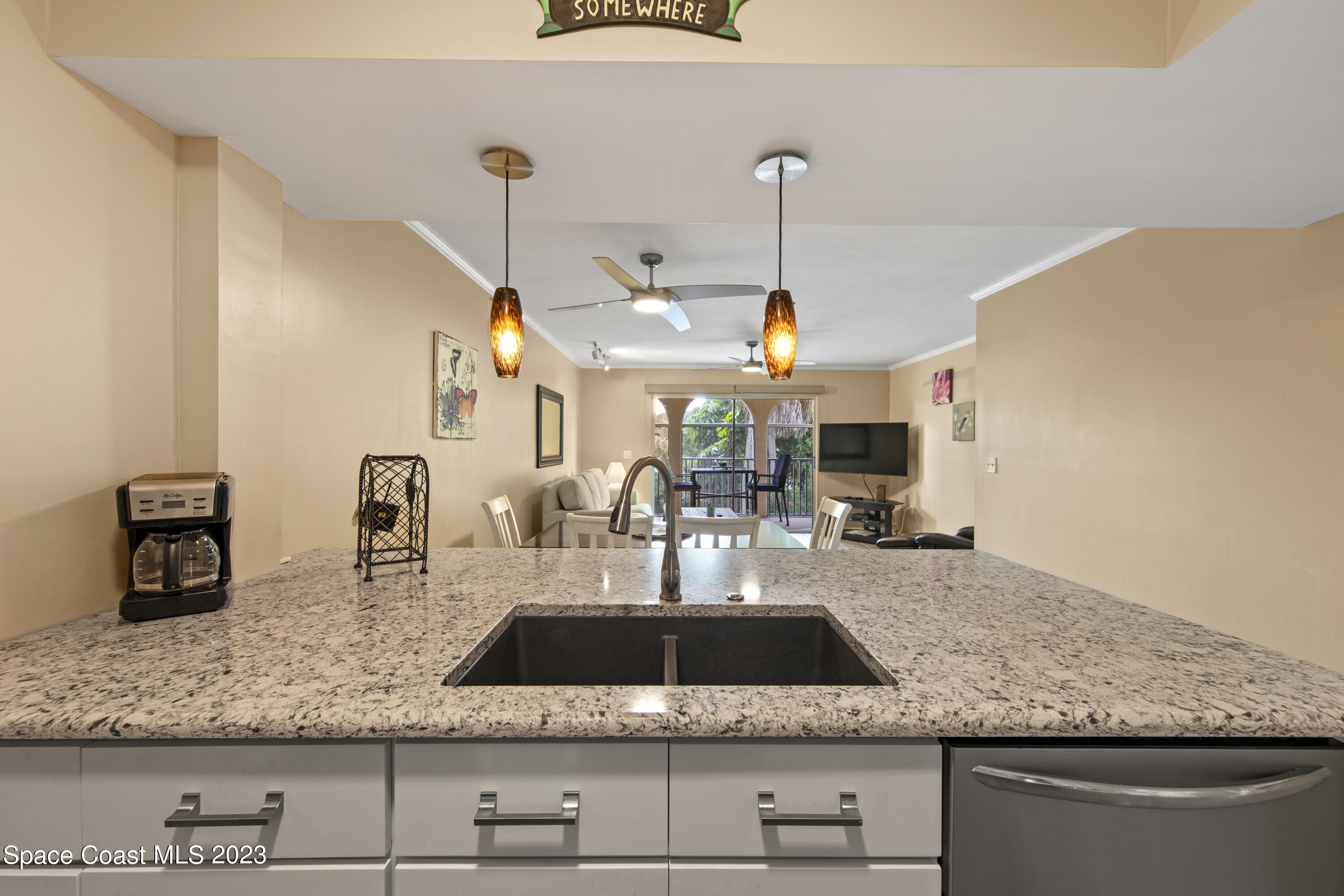 4150 Florida A1A, Unit 104 Vero Beach, FL 32963 - Photo 13 of 30 a kitchen with stainless steel appliances granite countertop a sink a counter space and cabinets