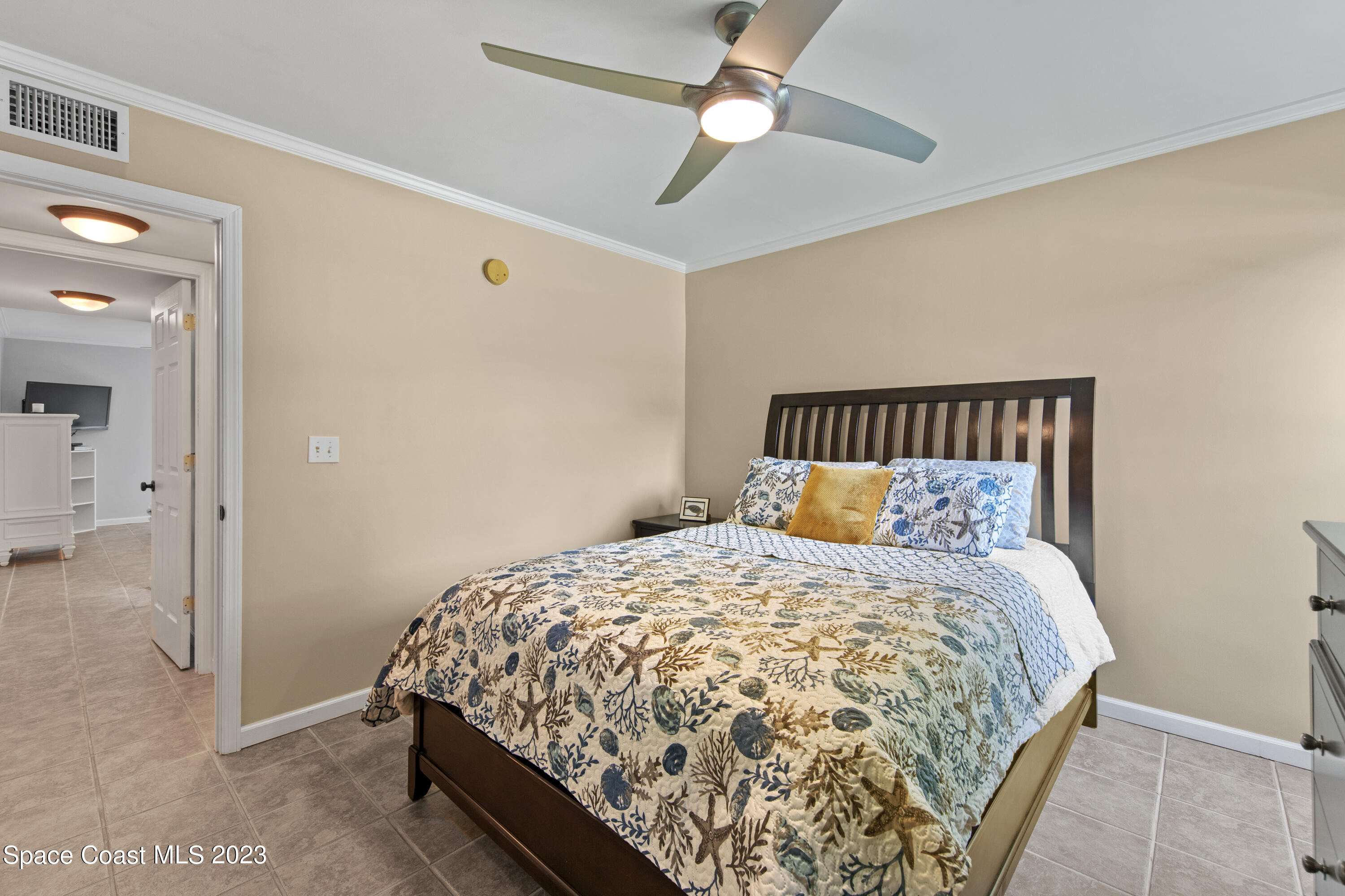 4150 Florida A1A, Unit 104 Vero Beach, FL 32963 - Photo 15 of 30 a bed sitting in a bedroom next to a bathroom