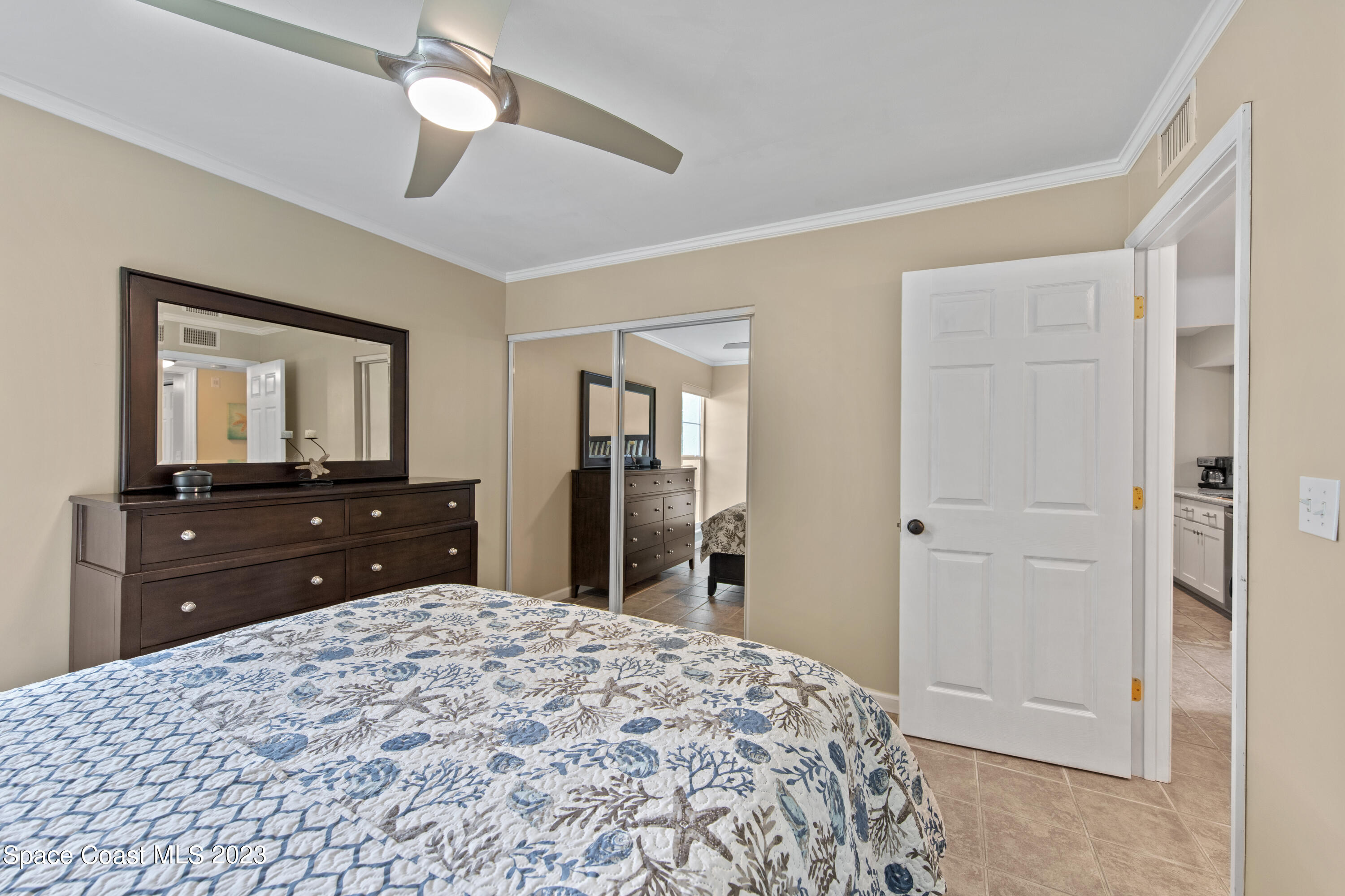 4150 Florida A1A, Unit 104 Vero Beach, FL 32963 - Photo 16 of 30 a bedroom with a bed and a dresser
