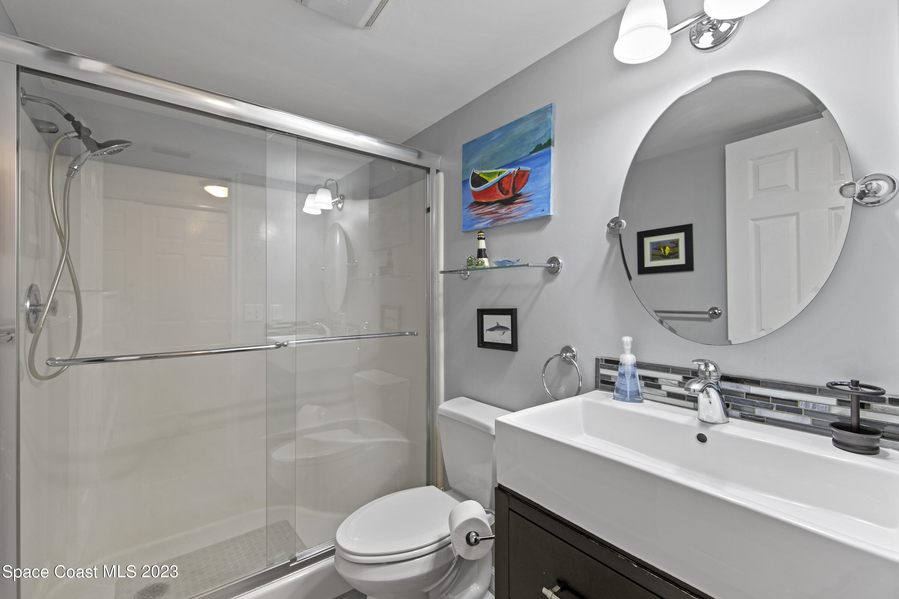 4150 Florida A1A, Unit 104 Vero Beach, FL 32963 - Photo 18 of 30 a bathroom with a sink toilet and shower