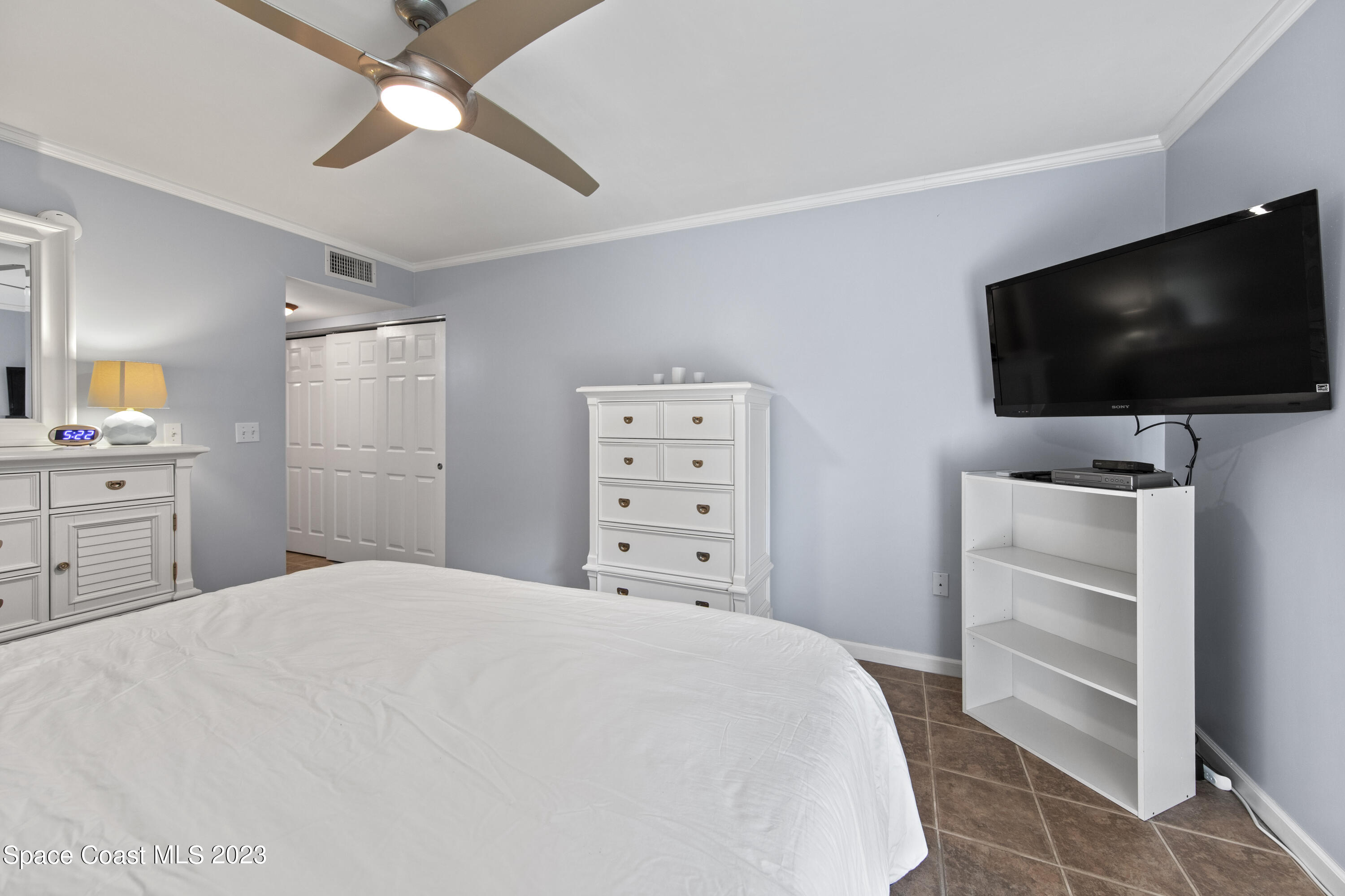 4150 Florida A1A, Unit 104 Vero Beach, FL 32963 - Photo 21 of 30 a room with a bed and a flat screen tv